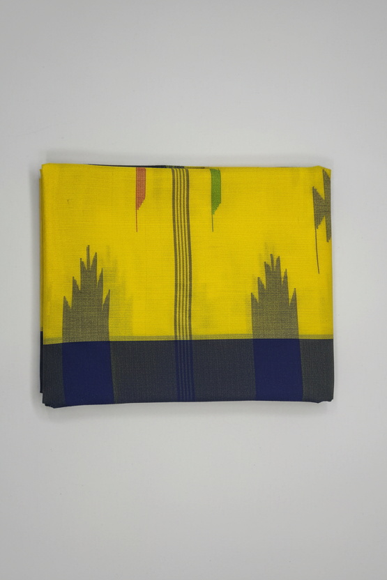 A folded yellow fabric item, likely a saree or scarf, featuring a geometric pattern with a navy blue border, gray motifs, and thin vertical stripes, displayed against a neutral light gray background.